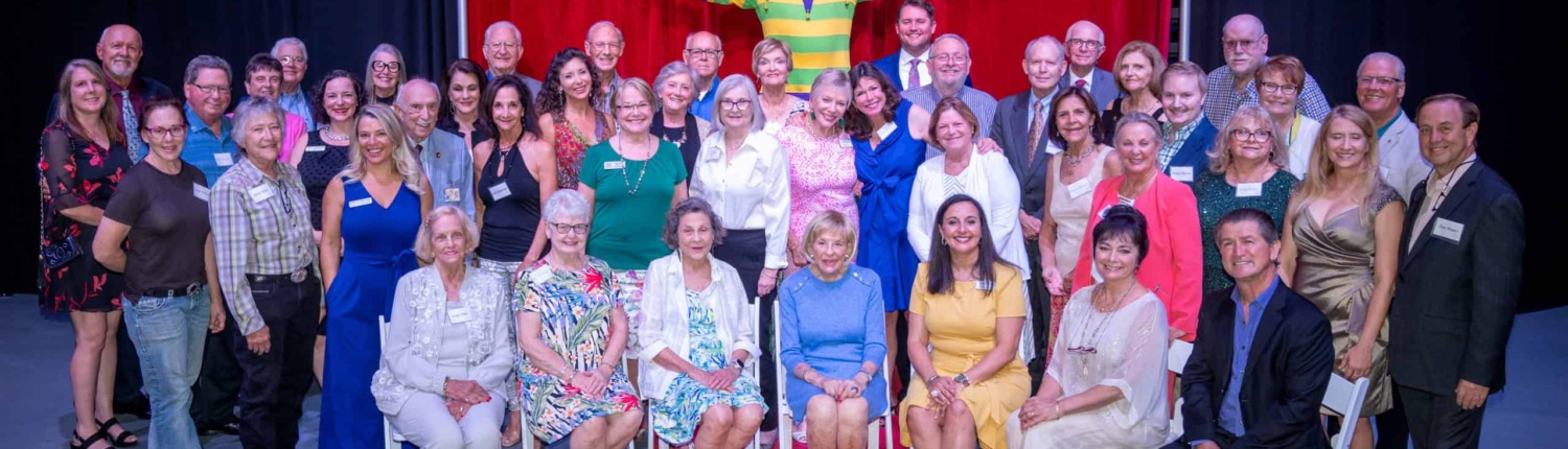 Center Ring Group Vibrant circus stage with performers and staff celebrating at Circus Arts Conservatory.