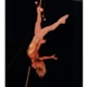 Aerial acrobat performing on a circus aerial silks rig for circus staging and performance art.