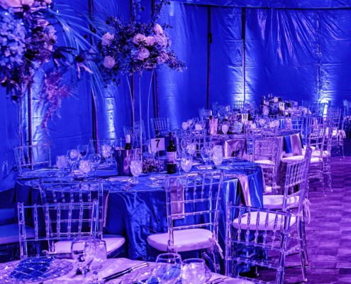 Luxury circus staging with elegant table settings and floral centerpieces for event decor.