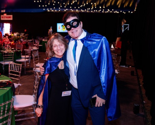 Vivid circus staging with performers in colorful costumes and vibrant lighting.