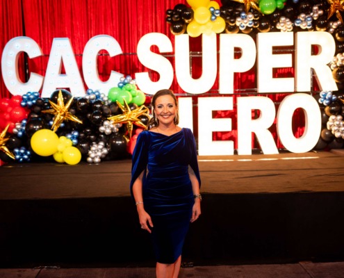 Colorful circus staging with vibrant balloons and large illuminated letters.