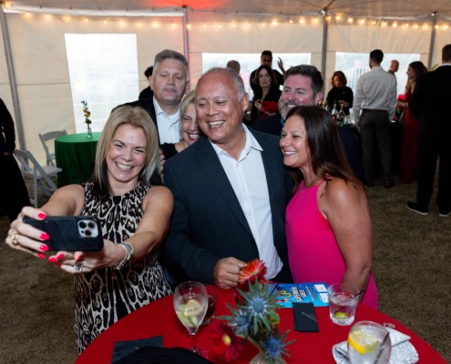 Brightly lit circus staging with guests enjoying a lively event under a large tent.