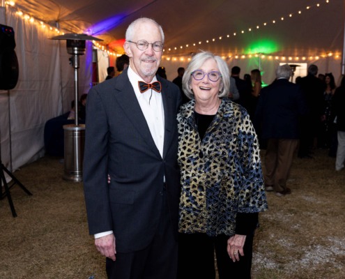 Elegant adults at circus event, formal attire, vibrant lighting, decorated tent, entertainment, celebration, night party, entertainment venue, social gathering, special occasion, festivity, outdoor event, cheerful ambiance, sophisticated dress, evening celebration.