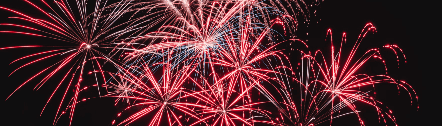 Vibrant fireworks display over a dark night sky, perfect for circus staging and entertainment events.